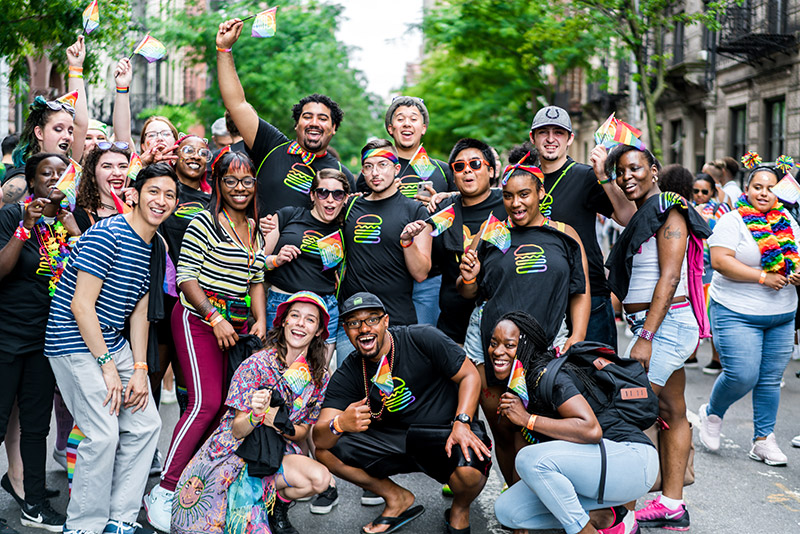 A group of people wearing Shake Shack pride shirts