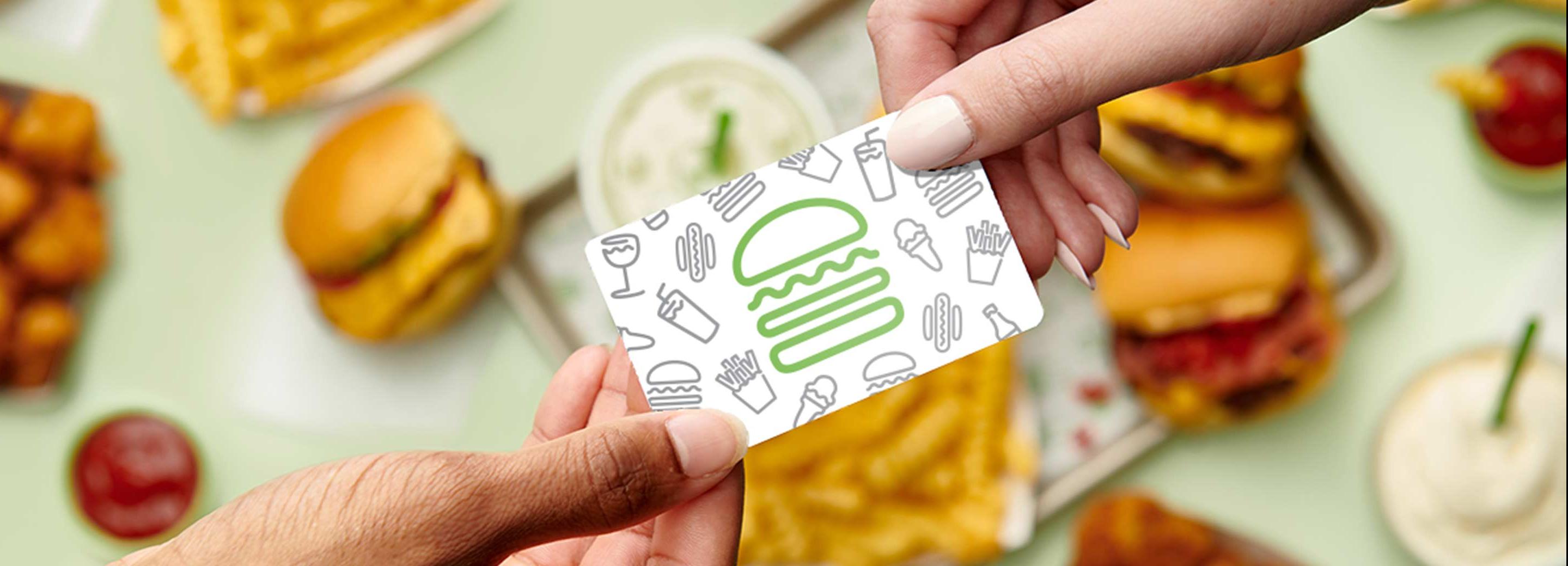 Hands passing a gift card between each other